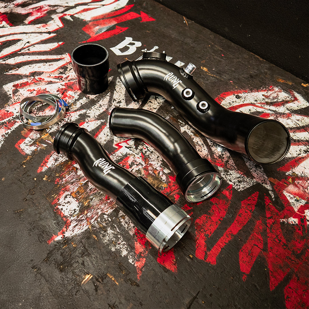 RVNG BMW M2 N55 Charge Boost Pipe Kit featuring precision-engineered black pipes and hardware for improved turbo airflow and durability.